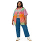 A plus size model with brown skin is wearing a colorful rainbow gradient button down shirt.