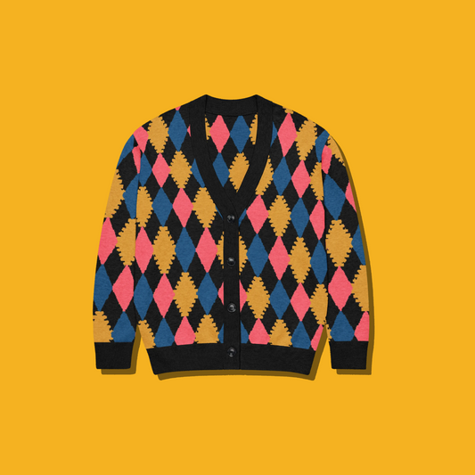 A long-sleeve button-front cardigan sweater with a colorful argyle diamond pattern, laid flat against a solid mustard yellow background.
