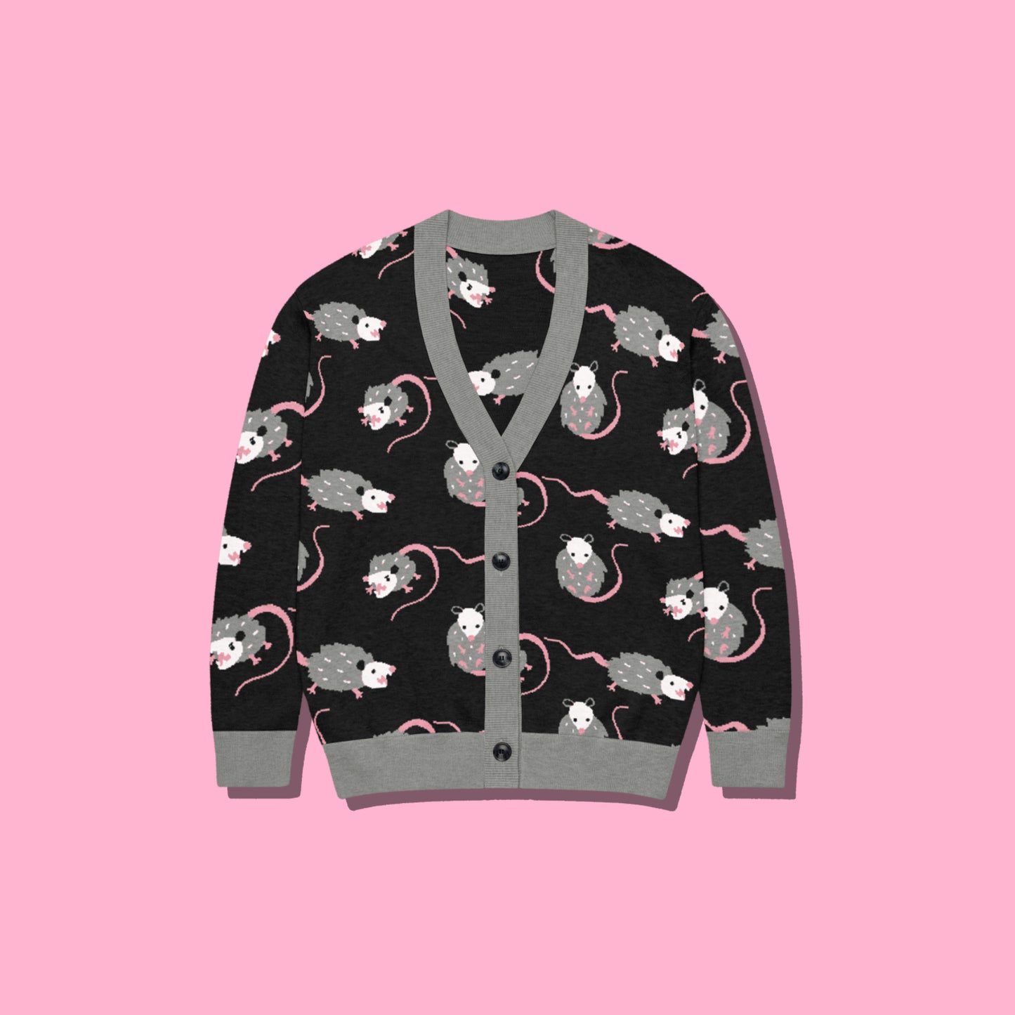 A cute opossum cardigan sweater with a black base and with a gray, white, and pink opossum pattern on a pink background.