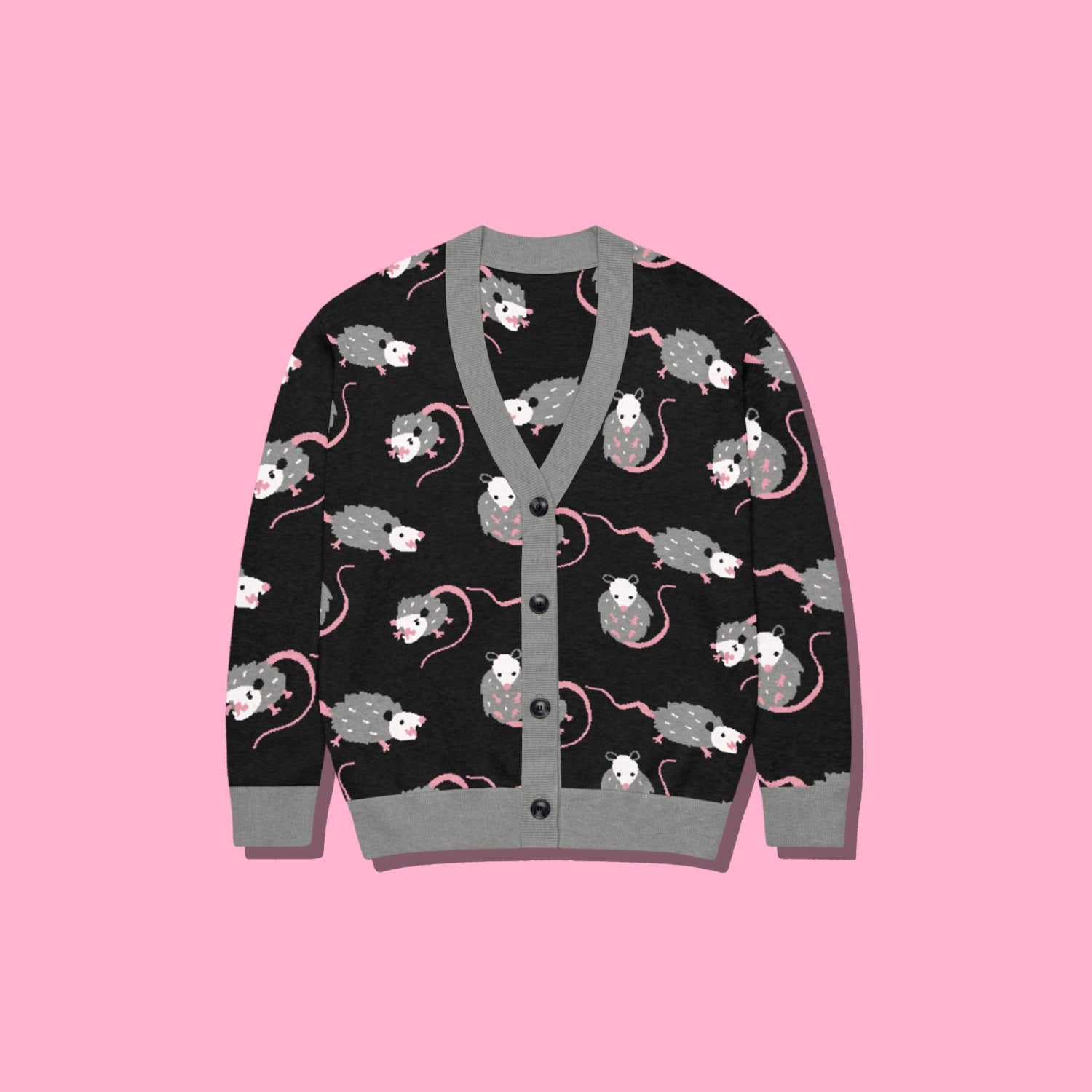 A cute opossum cardigan sweater with a black base and with a gray, white, and pink opossum pattern on a pink background.